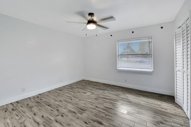 empty room with light hardwood / wood-style floors and ceiling fan