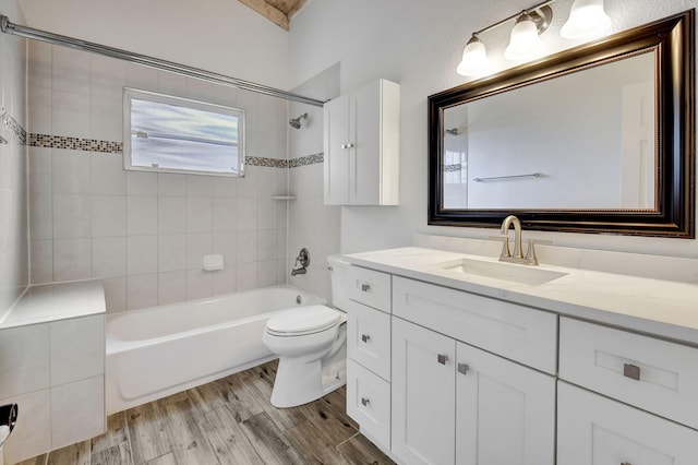 full bathroom featuring vanity, toilet, tiled shower / bath combo, and hardwood / wood-style floors