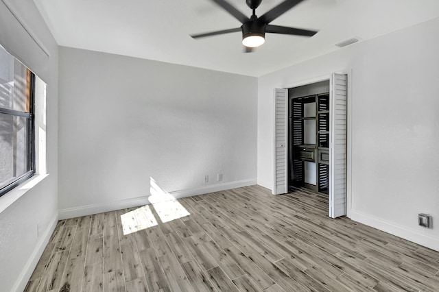 spare room featuring light hardwood / wood-style flooring and ceiling fan