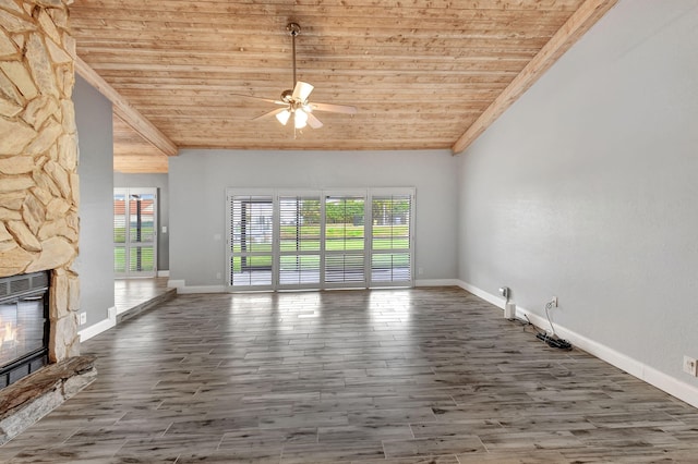 unfurnished living room with a fireplace, wooden ceiling, and a healthy amount of sunlight