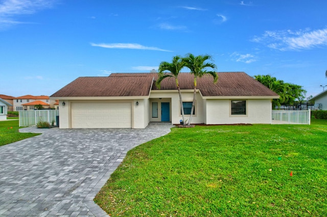 ranch-style home with a garage and a front lawn