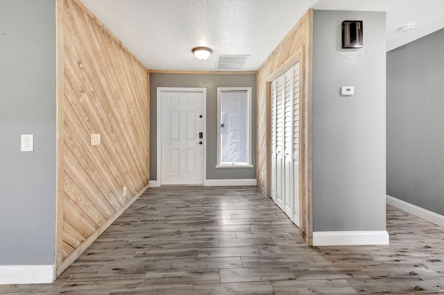 foyer with hardwood / wood-style flooring and a textured ceiling