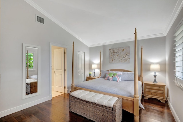 bedroom with crown molding, vaulted ceiling, and dark hardwood / wood-style floors