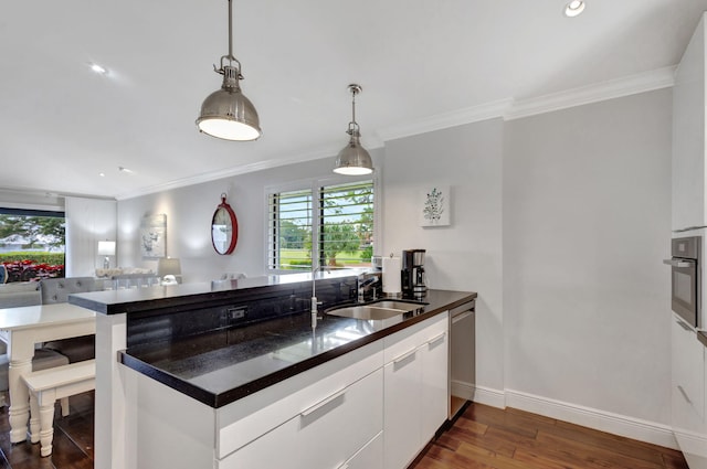 kitchen featuring crown molding, stainless steel appliances, dark hardwood / wood-style floors, and white cabinets