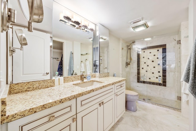 bathroom with vanity, toilet, and a shower with shower door