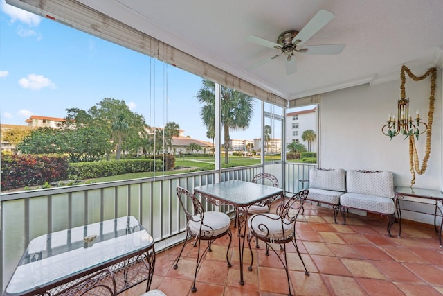 sunroom featuring ceiling fan