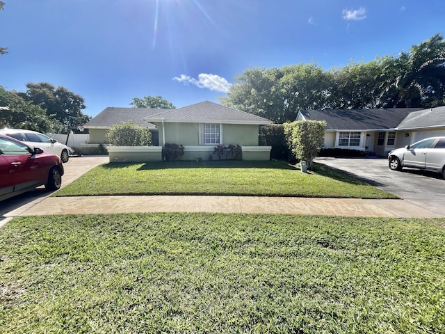 single story home featuring a front yard