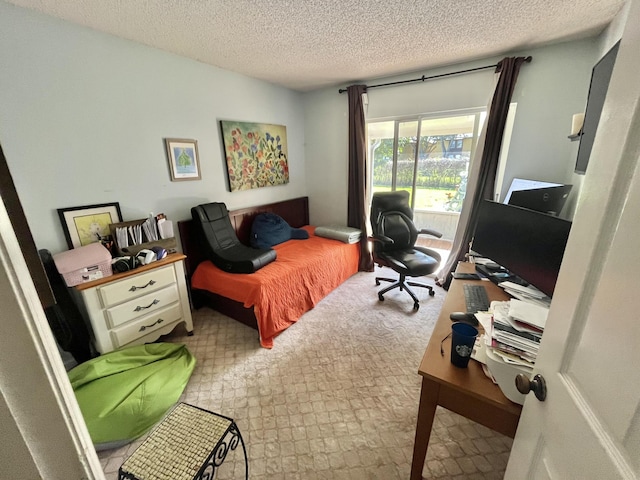 bedroom featuring access to outside and a textured ceiling