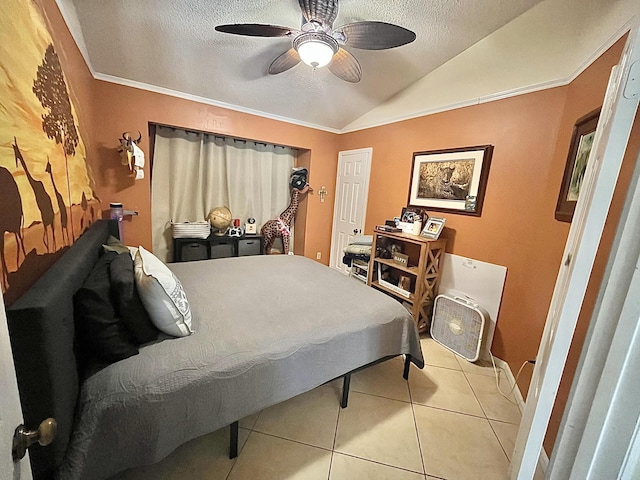 bedroom with light tile patterned flooring, lofted ceiling, a textured ceiling, ornamental molding, and ceiling fan