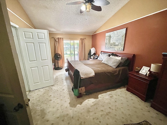 bedroom featuring lofted ceiling, ceiling fan, access to exterior, a textured ceiling, and light carpet