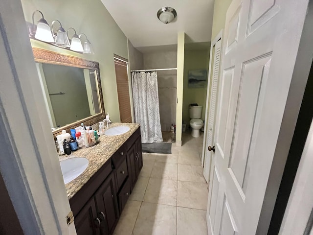 bathroom with tile patterned flooring, vanity, curtained shower, and toilet