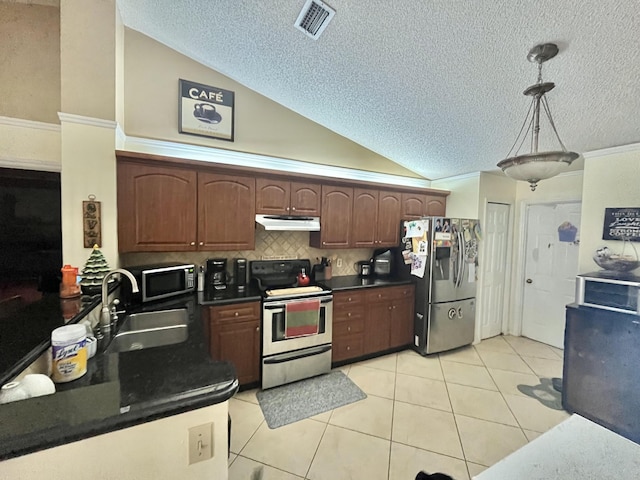 kitchen featuring sink, decorative light fixtures, stainless steel appliances, and light tile patterned floors