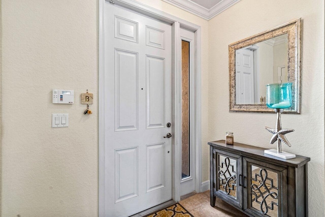 tiled entryway featuring crown molding