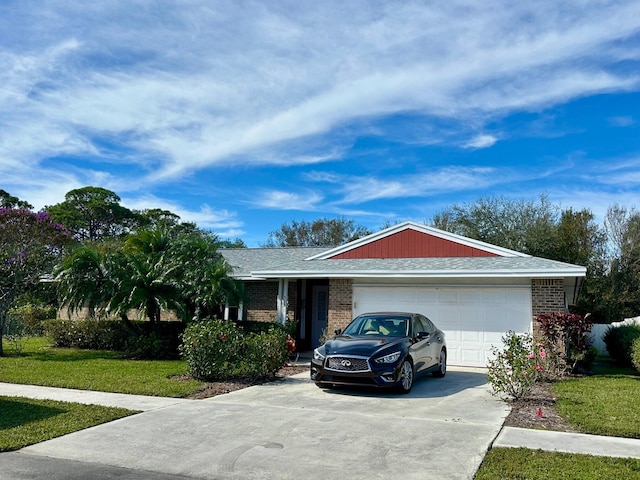 ranch-style house featuring a garage, brick siding, driveway, and a front lawn