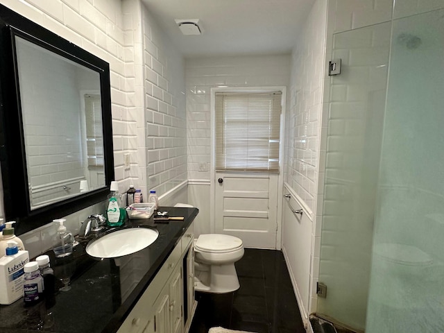 bathroom featuring a stall shower, vanity, and toilet