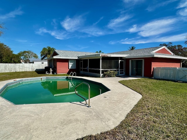 view of swimming pool featuring a patio, a fenced backyard, a sunroom, a yard, and a fenced in pool