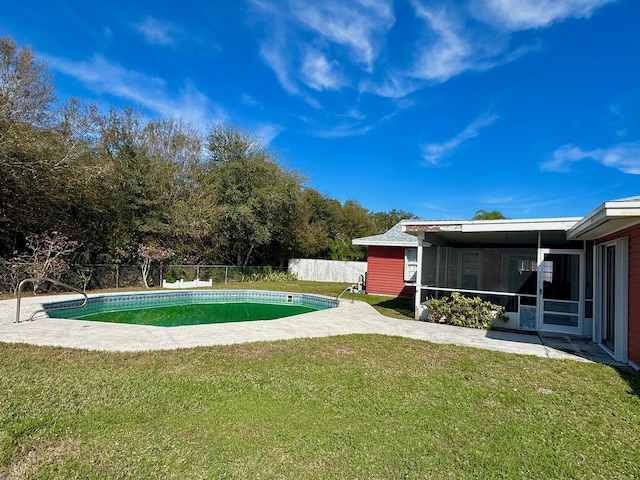 view of yard featuring a fenced in pool, a sunroom, and a fenced backyard