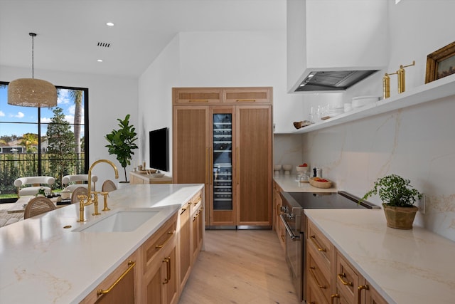 2578 Players Ct, Wellington, FL 33414 - kitchen with sink, high end range, custom range hood, pendant lighting, and light stone countertops