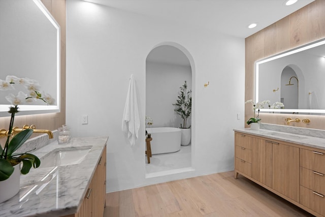 2578 Players Ct, Wellington, FL 33414 - bathroom with hardwood / wood-style flooring, vanity, and a tub to relax in