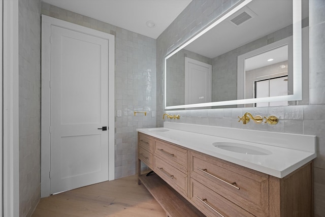2578 Players Ct, Wellington, FL 33414 - bathroom featuring backsplash, wood-type flooring, tile walls, and vanity