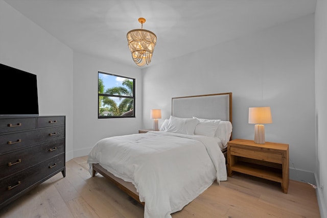 2578 Players Ct, Wellington, FL 33414 - bedroom featuring an inviting chandelier and light wood-type flooring