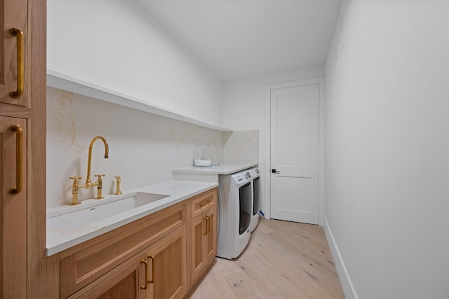 2578 Players Ct, Wellington, FL 33414 - laundry room with sink, washer and clothes dryer, cabinets, and light wood-type flooring