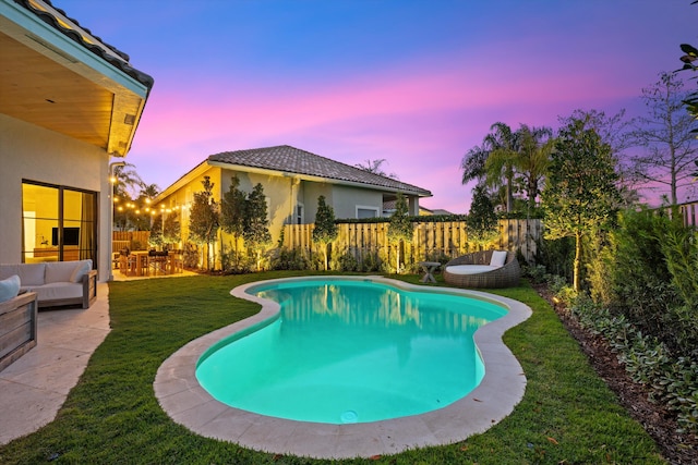 2578 Players Ct, Wellington, FL 33414 - pool at dusk featuring a yard, outdoor lounge area, and a patio
