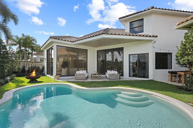 2578 Players Ct, Wellington, FL 33414 - rear view of house with a fenced in pool, a yard, an outdoor living space with a fire pit, and a patio
