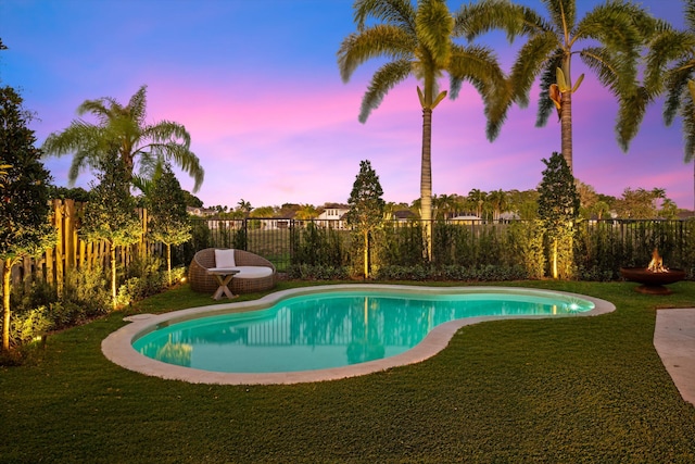 2578 Players Ct, Wellington, FL 33414 - pool at dusk featuring a lawn
