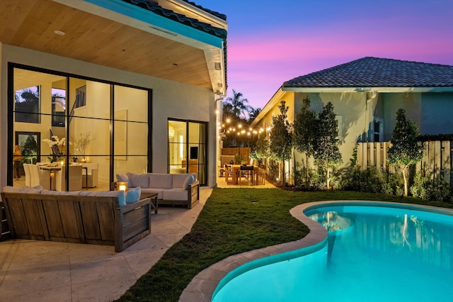 2578 Players Ct, Wellington, FL 33414 - pool at dusk featuring outdoor lounge area and a patio
