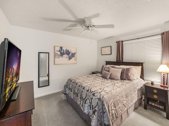 carpeted bedroom with ceiling fan and a textured ceiling