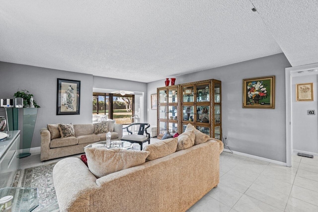 tiled living room featuring a textured ceiling