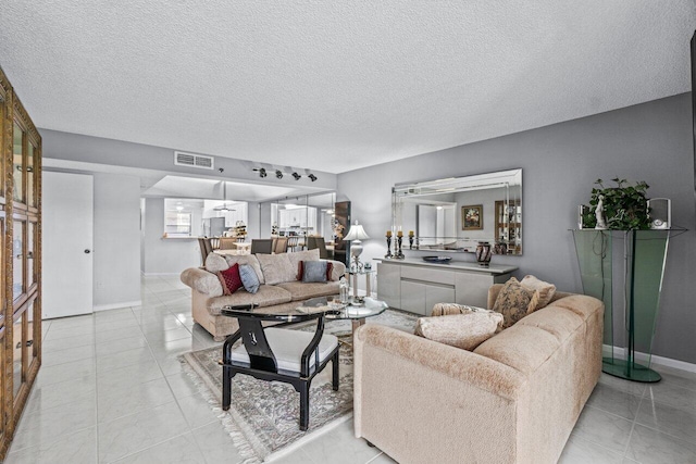 living room featuring light tile patterned floors and a textured ceiling