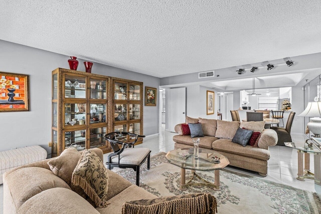 tiled living room with a textured ceiling