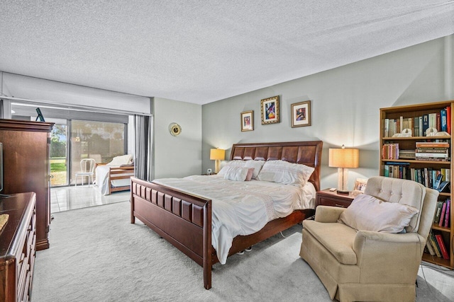 carpeted bedroom featuring access to outside and a textured ceiling