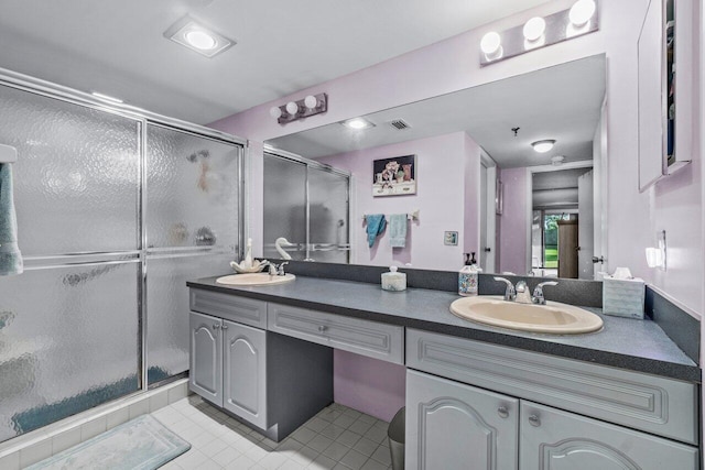 bathroom with tile patterned flooring, vanity, and walk in shower