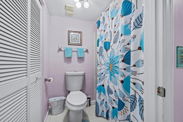 bathroom with walk in shower, tile patterned floors, and toilet