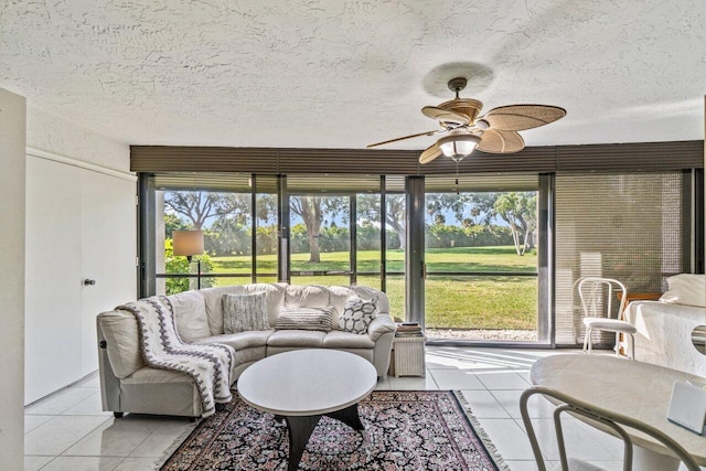 sunroom / solarium featuring ceiling fan