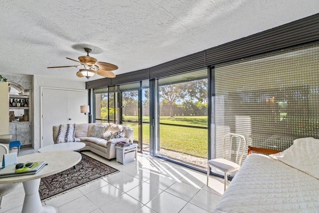 sunroom featuring ceiling fan