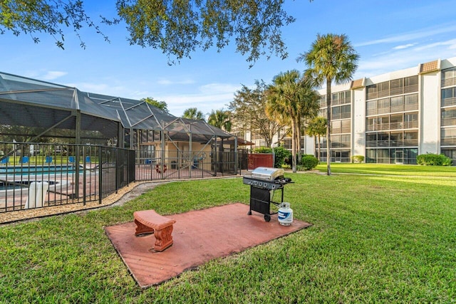 view of yard with a community pool and glass enclosure