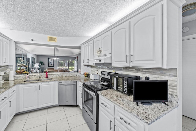 kitchen with stainless steel appliances, white cabinetry, sink, and pendant lighting