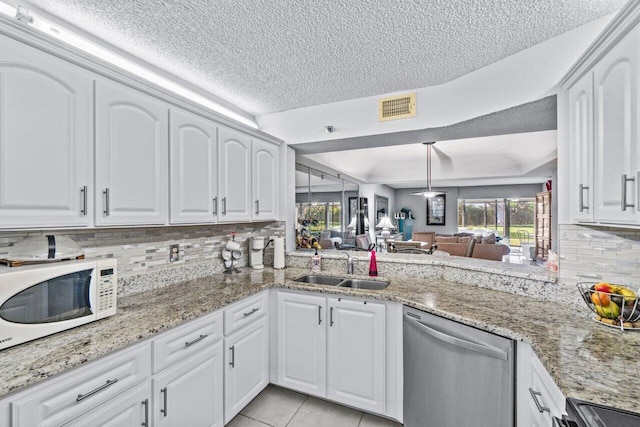 kitchen with sink, dishwasher, range, white cabinets, and kitchen peninsula