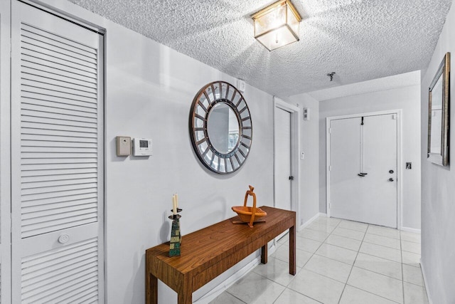 interior space featuring a textured ceiling and light tile patterned flooring