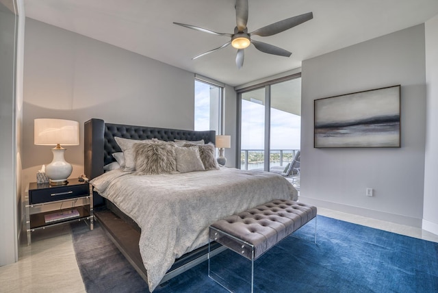 bedroom featuring access to outside, expansive windows, and ceiling fan