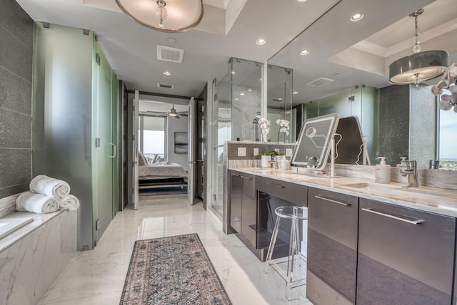 bathroom featuring vanity, a wealth of natural light, and a shower with door