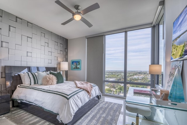 bedroom featuring expansive windows and ceiling fan