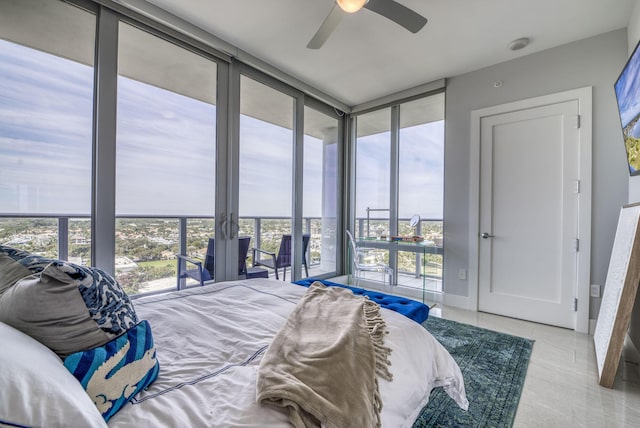 bedroom with multiple windows, floor to ceiling windows, access to exterior, and ceiling fan