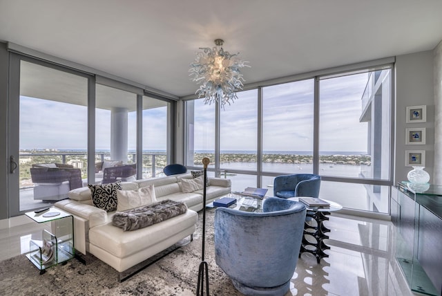 living room featuring a wall of windows, a chandelier, a healthy amount of sunlight, and a water view