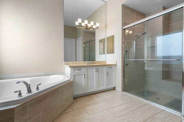 bathroom featuring vanity, shower with separate bathtub, and a notable chandelier