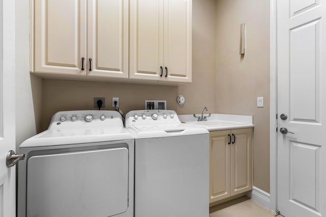 laundry area with cabinets, sink, and washer and clothes dryer